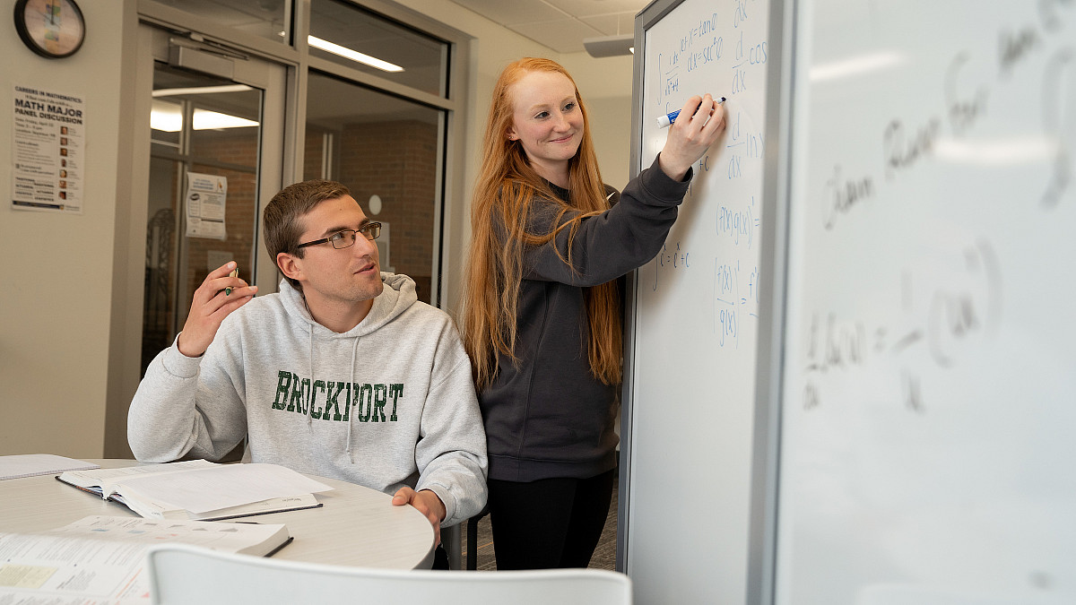 Student tutor helping another student in the Academic Success Center