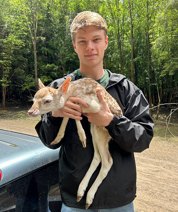 Nathan Franklin holding an animal at his internship with Animal Adventure Park
