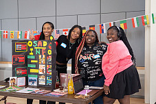 Students gathered around an information table for the Organization for Students of African Descent
