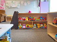 Toy cars, trucks, and trains on a shelf