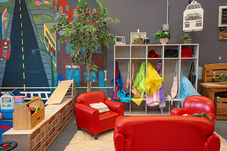 a red chair and sofa for children in a classroom