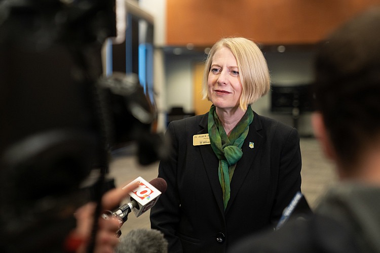 President Macpherson speaking to news reporters.