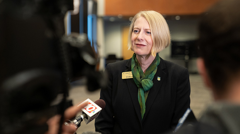 President Macpherson speaking to news reporters.