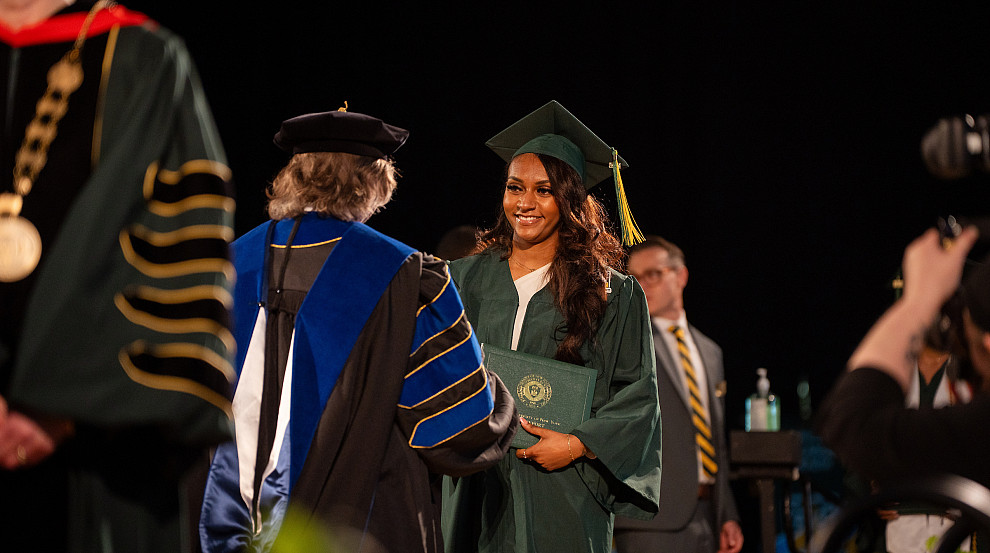 undergraduate student walking the stage during commencement