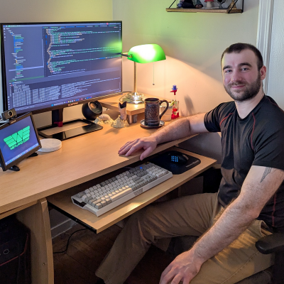 Michael Amico sitting at his home office space and posing for the camera