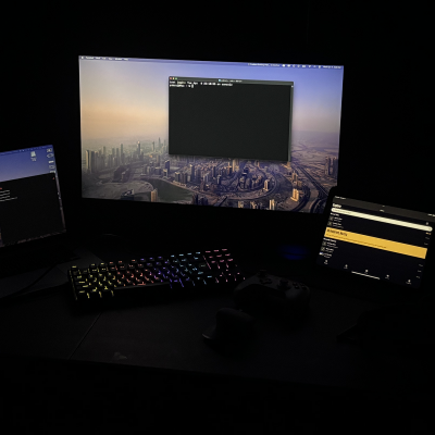 Yubraj Kahtri's workspace with several monitors in a dark room
