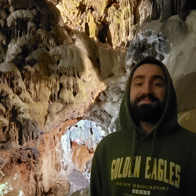 Jason Cook posing for the camera in a cavern located in Le Roy, New York