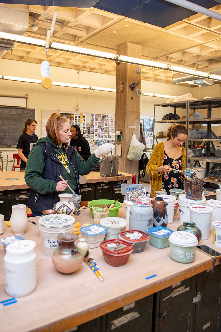 Student in an art room on campus for Scholars Day.