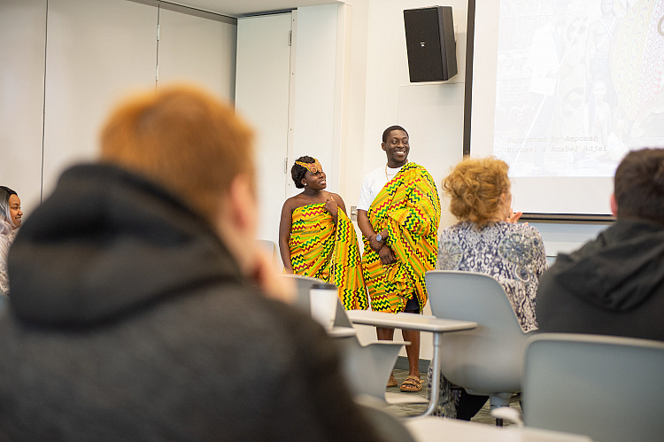 Students presenting on Scholars Day in a classroom on campus.