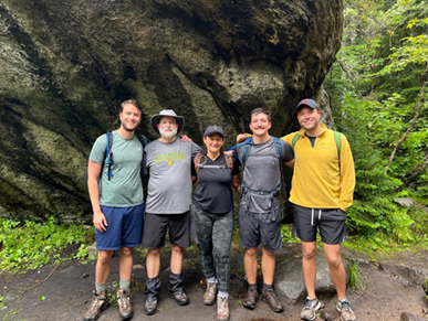 Steve Cook and friends posing for the camera at a hiking trail