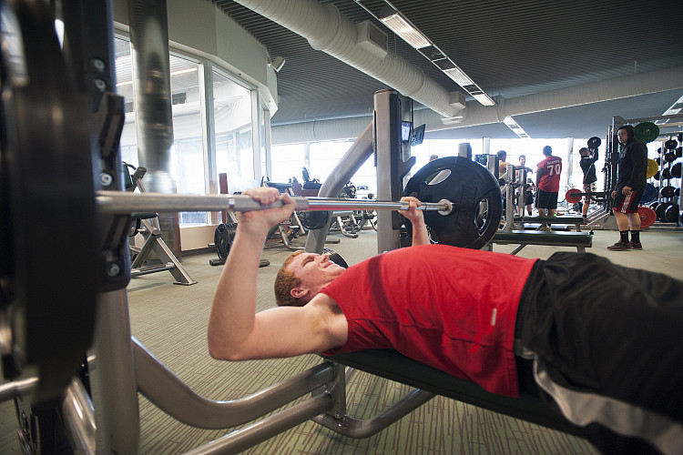 student lifting weights in the Fitness Center