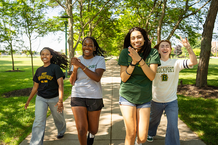 four students walking and cheering