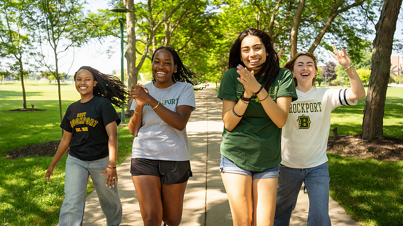 four students walking and cheering