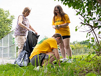 Students and staff picking up trash at a local playground for Saturday of Service.