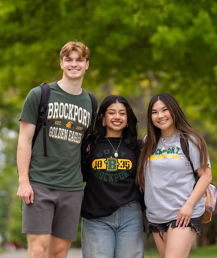 Three students standing outside.