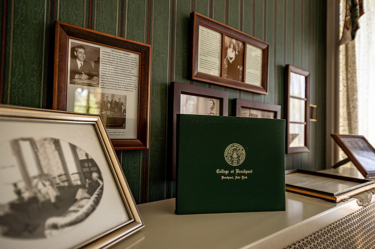 Close up of dipolma and pictures in Alumni House