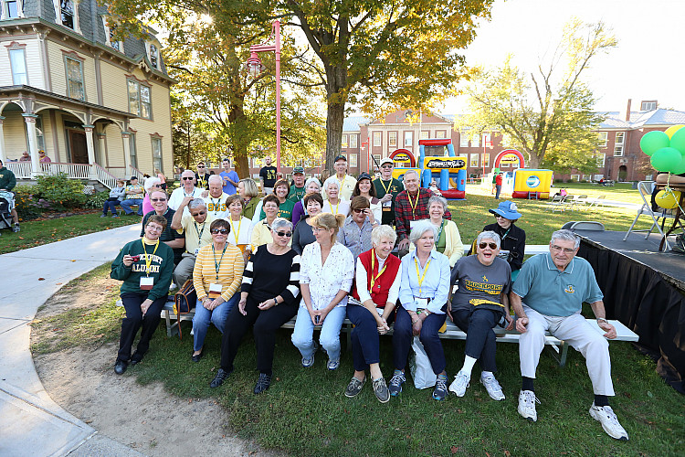 Group of Brockport alums sitting on lawn