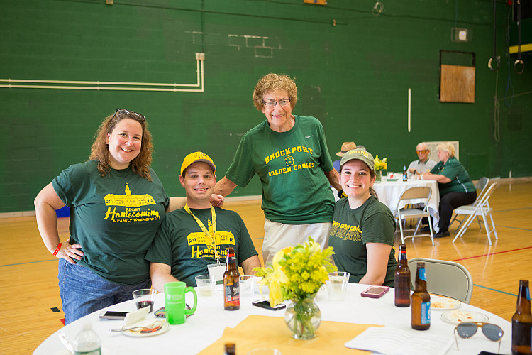 Older alums at table at Homecoming.