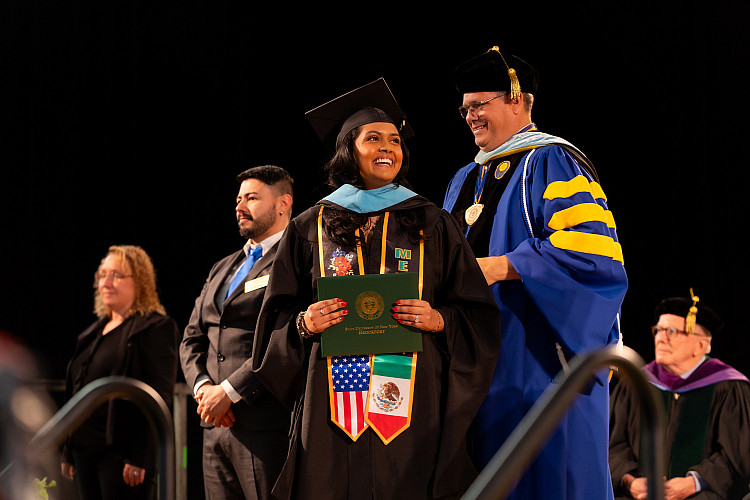 Student on stage at commencement.
