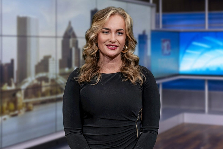 Brockport student in news studio.