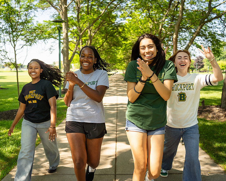 suny brockport students walking toward camera cheering