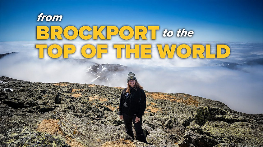 student standing on top of a mountain with the words from brockport to the world