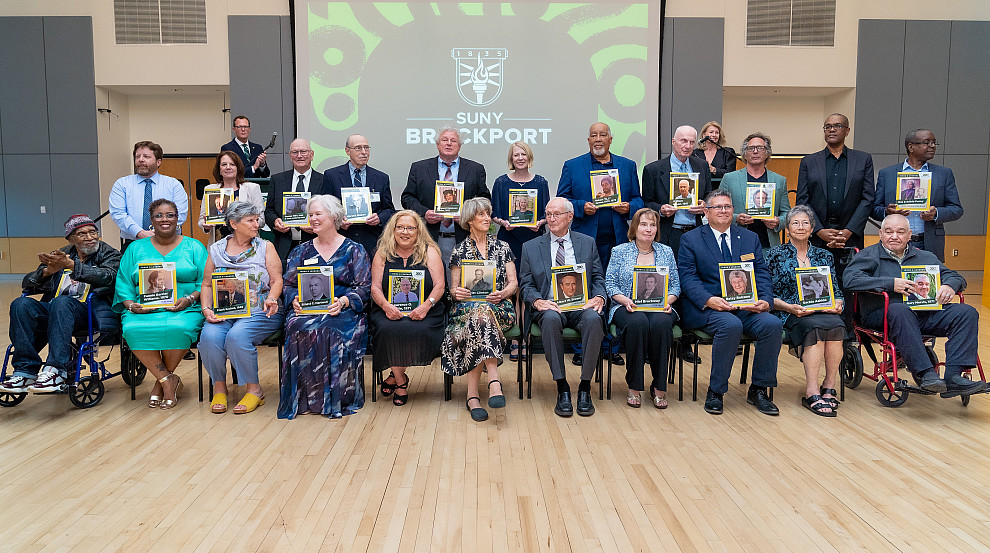 Twenty people with icons and legends cards at event.