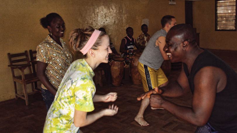 Group of Brockport students dancing with people from Ghana