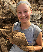 Evelyn Patterson with a fragmented roof tile from SPU 7. Photo by Dr. Alex Smith.