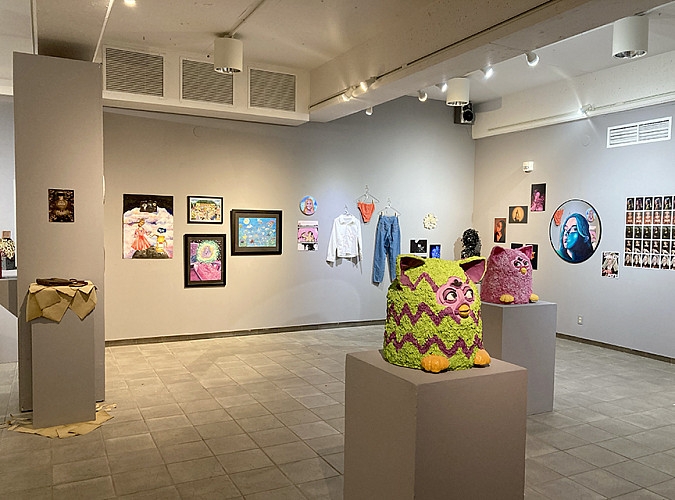 Various art pieces displayed on walls and pillars at the 2024 Student Art and Design Exhibit