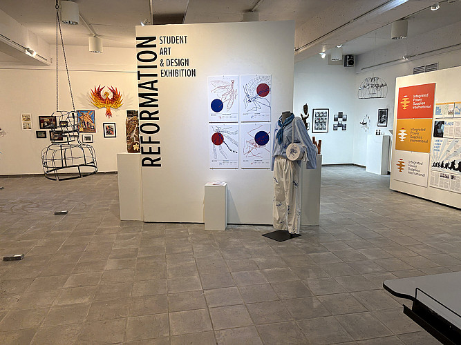Various art pieces displayed on walls and pillars at the 2026 Student Art and Design Exhibit
