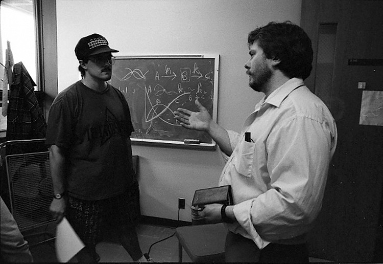 Professor David Dwyer (right) in his office with a student in 1992.