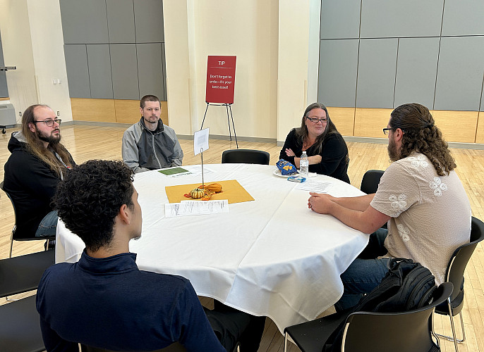 Students networking with representative from Montefiore Einstein