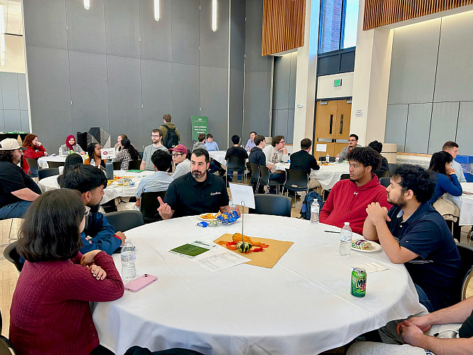 Students networking with representative from Pellera Technologies