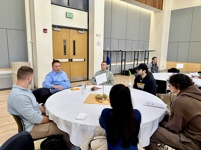 Students networking with representative from Belvista Software