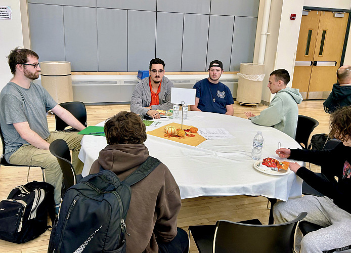 Students networking with representative/alum, Garret Suhr from ComTec Solutions