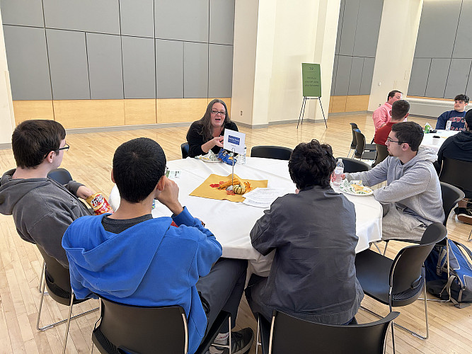 Students networking with representative from Montefiore Einstein
