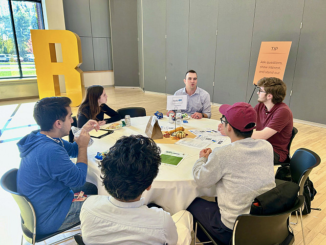 Students networking with representative from Excellus