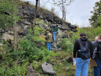 Geology Students looking at a rock face and taking notes