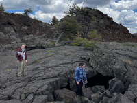 Geology students traversing a rocky field