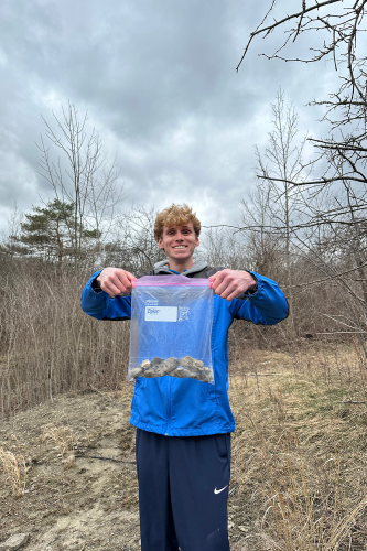 Earth Science student holding up a bag partially filled with rocks