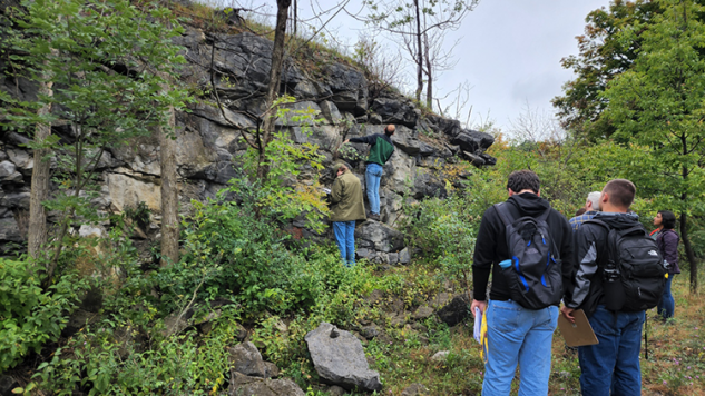 Geology Students looking at a rock face and taking notes