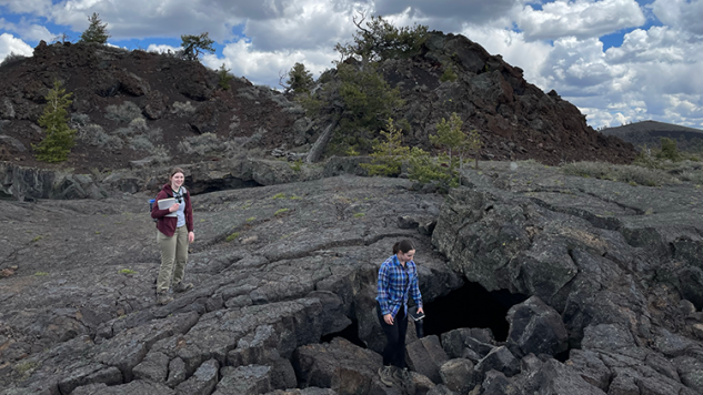 Geology students traversing a rocky field