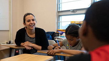 Teacher smiling while talking to students