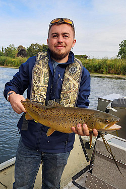 Dan Beers and brown trout during field work