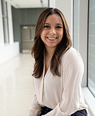 student poses in the hallway of academic building