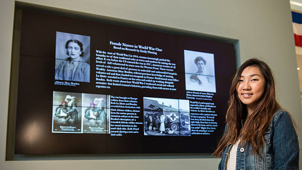 Emily Flemming standing in front of her project