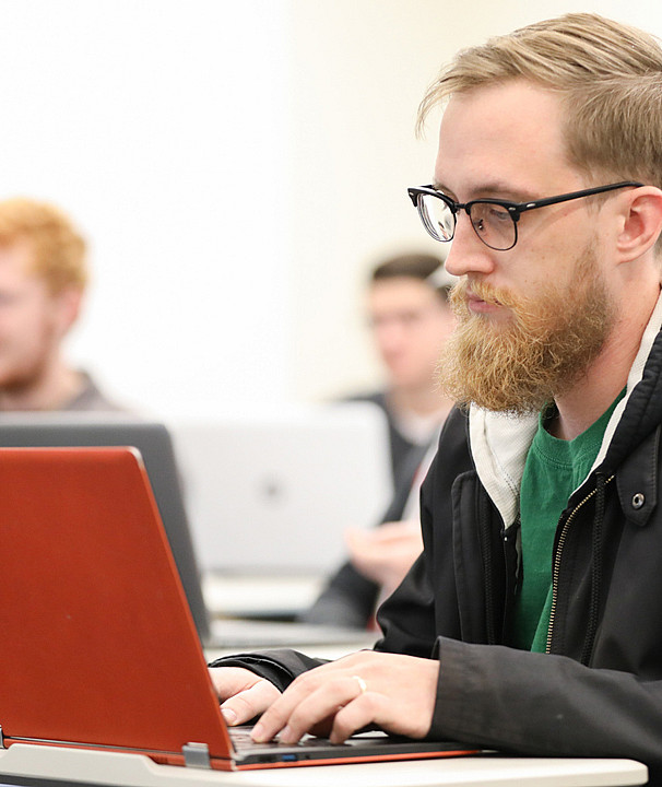 Student Works on a Laptop in Classroom