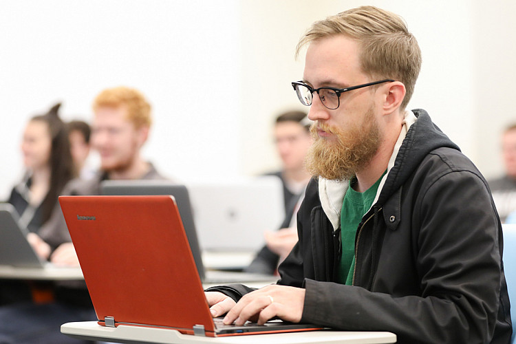Student Works on a Laptop in Classroom