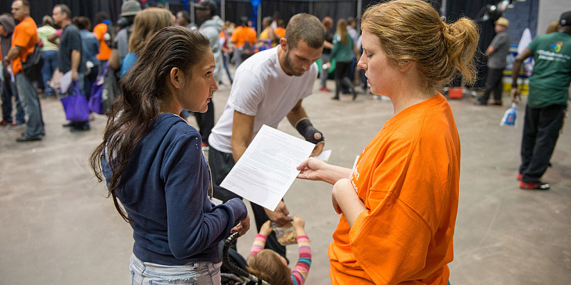 Social Work student helping a family at Homeless Connect event